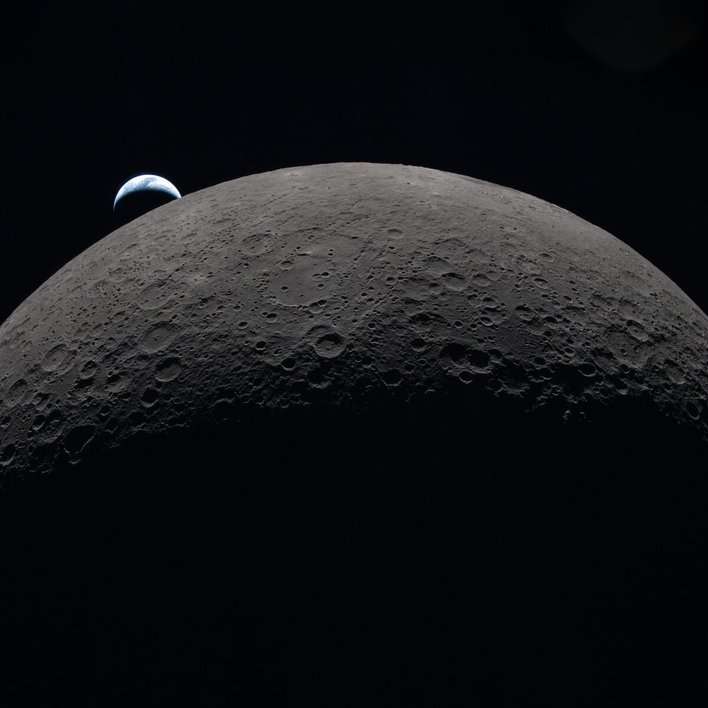 The Moon's curved limb with Orientale basin and Hertzsprung Basin visible, Earth setting on the horizon, photographed by Artemis II